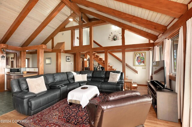 37905 Hall Rd, Sterling, AK 99672 - living room featuring light wood-type flooring, stairs, high vaulted ceiling, and a wooden ceiling with exposed beams