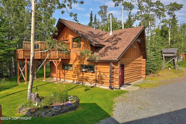 37905 Hall Rd, Sterling, AK 99672 - view of front of home featuring log siding, a front lawn, a shingled roof, and a deck