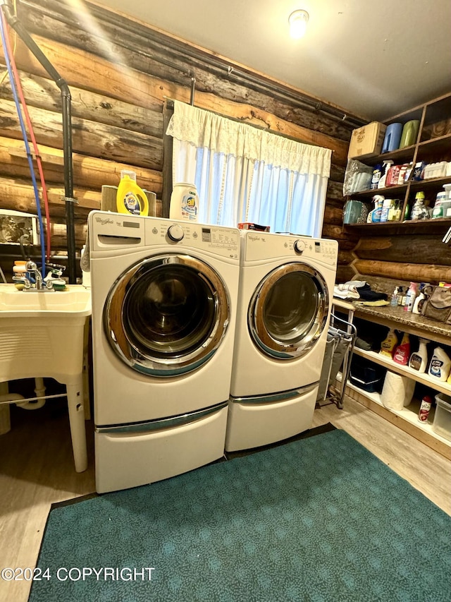 37905 Hall Rd, Sterling, AK 99672 - laundry room with washing machine and clothes dryer, wood finished floors, and rustic walls