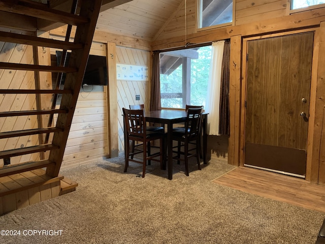 37905 Hall Rd, Sterling, AK 99672 - carpeted dining area featuring wood walls, vaulted ceiling, wooden ceiling, and stairs