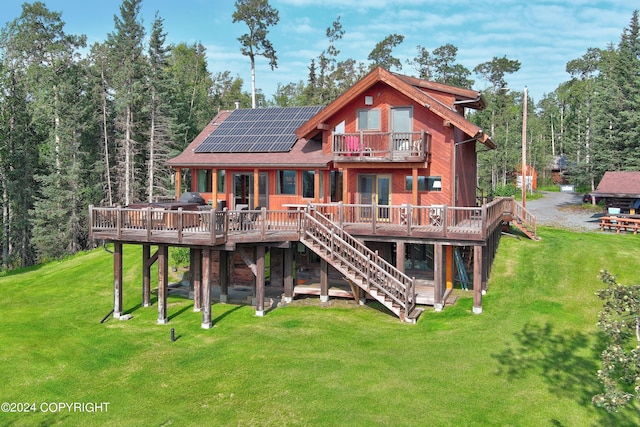 37905 Hall Rd, Sterling, AK 99672 - back of property featuring stairway, a deck, a lawn, and roof mounted solar panels