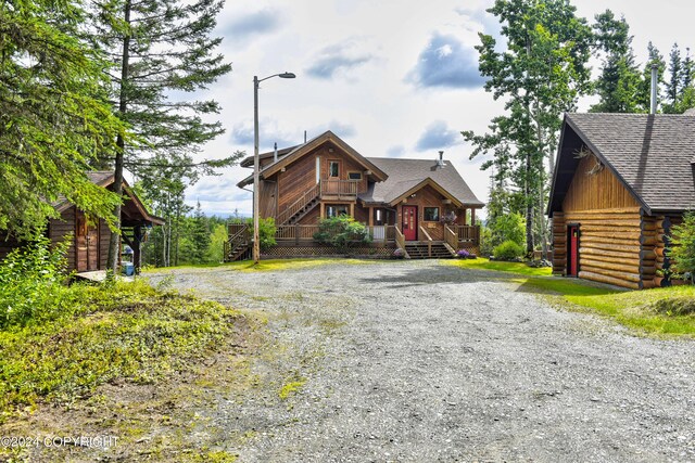 37905 Hall Rd, Sterling, AK 99672 - view of front facade featuring gravel driveway, stairs, log exterior, and roof with shingles