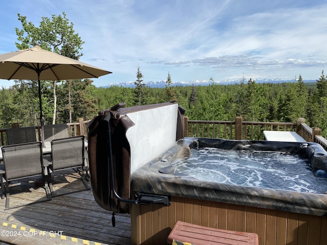 37905 Hall Rd, Sterling, AK 99672 - wooden terrace with a hot tub, a wooded view, and outdoor dining space