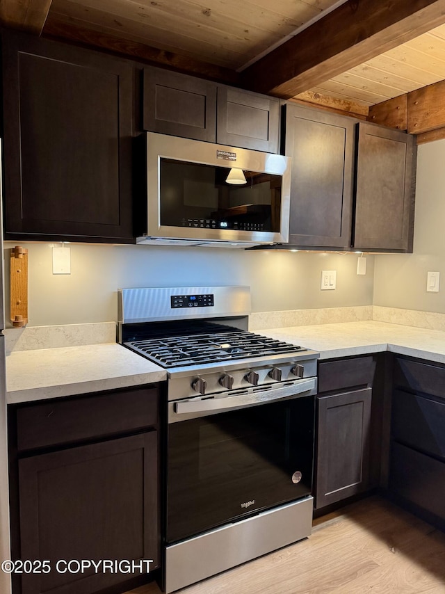 37905 Hall Rd, Sterling, AK 99672 - kitchen with stainless steel appliances, a wooden ceiling with exposed beams, light wood finished floors, light countertops, and dark brown cabinets