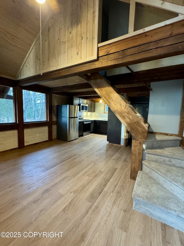 37905 Hall Rd, Sterling, AK 99672 - unfurnished living room featuring light wood-type flooring, stairway, vaulted ceiling, wood walls, and wood ceiling