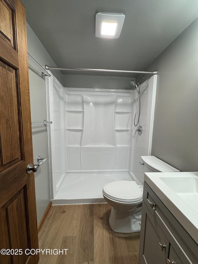 37905 Hall Rd, Sterling, AK 99672 - full bathroom featuring wood finished floors, vanity, and a shower