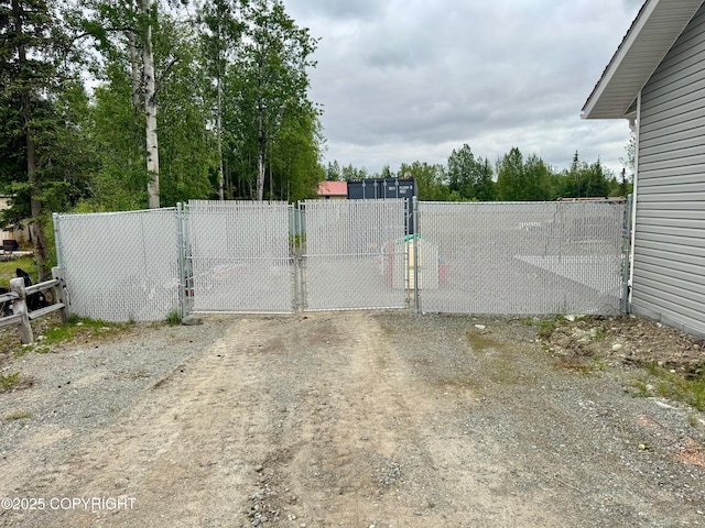 6780 W Blondell Dr, Wasilla, AK 99623 - gate featuring view of wooded area