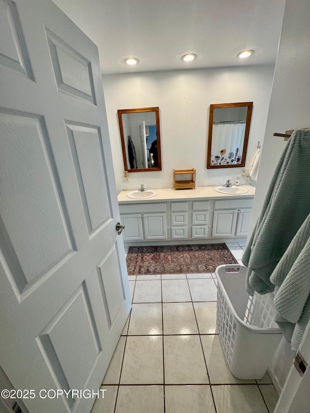 6780 W Blondell Dr, Wasilla, AK 99623 - full bathroom featuring double vanity, tile patterned floors, and recessed lighting