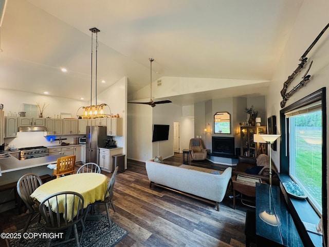 6780 W Blondell Dr, Wasilla, AK 99623 - living room featuring dark wood-style floors, a chandelier, and high vaulted ceiling