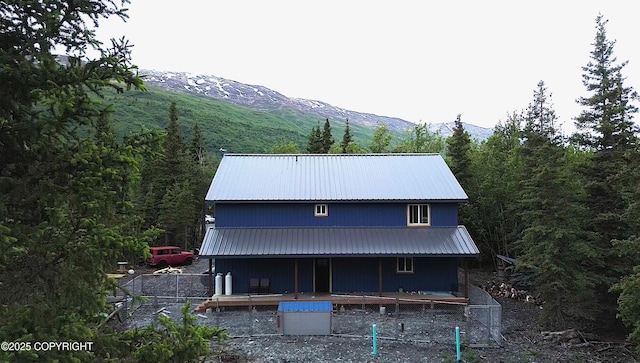 11157 S Berut Rd, Palmer, AK 99645 - back of house with a metal roof, a porch, a mountain view, and a wooded view