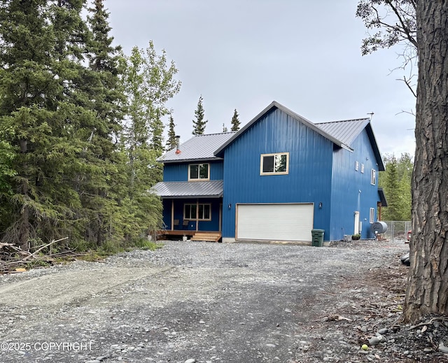 11157 S Berut Rd, Palmer, AK 99645 - view of front facade featuring covered porch, a metal roof, dirt driveway, and an attached garage