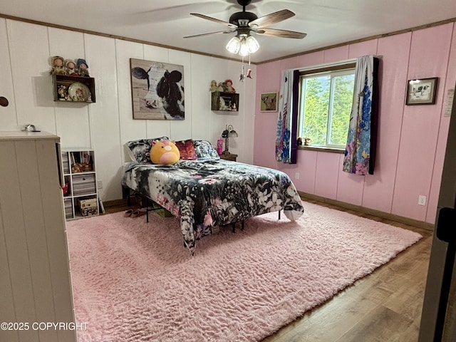11157 S Berut Rd, Palmer, AK 99645 - bedroom with a decorative wall, wood finished floors, ornamental molding, and ceiling fan