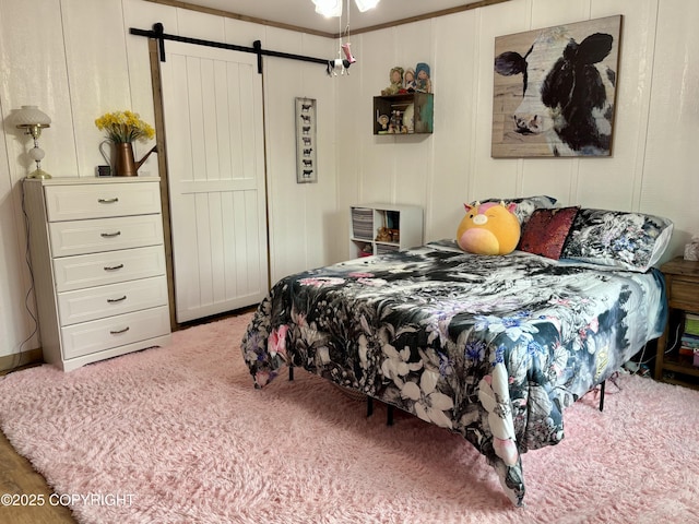 11157 S Berut Rd, Palmer, AK 99645 - bedroom featuring a barn door, carpet floors, and a decorative wall
