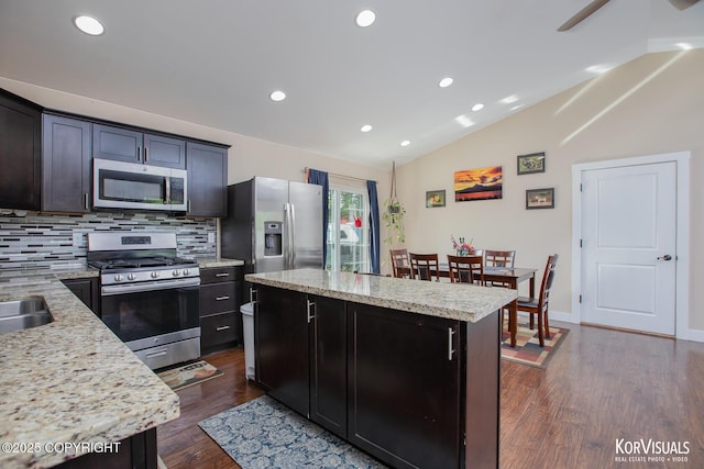1524 N Little Susitna Dr, Wasilla, AK 99654 - kitchen featuring stainless steel appliances, tasteful backsplash, a kitchen island, dark wood-type flooring, and lofted ceiling