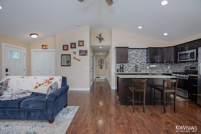1524 N Little Susitna Dr, Wasilla, AK 99654 - living area featuring vaulted ceiling, dark wood-style floors, ceiling fan, and recessed lighting