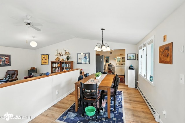 222 Crest Dr, Soldotna, AK 99669 - dining room with a baseboard heating unit, light wood-style floors, vaulted ceiling, a ceiling fan, and a chandelier