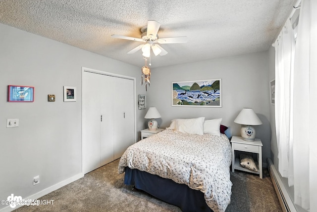 222 Crest Dr, Soldotna, AK 99669 - bedroom with baseboard heating, carpet, a closet, a textured ceiling, and a ceiling fan