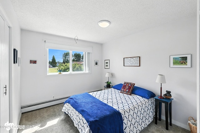 222 Crest Dr, Soldotna, AK 99669 - bedroom with baseboard heating, carpet, and a textured ceiling