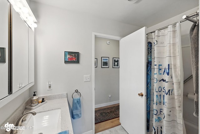 222 Crest Dr, Soldotna, AK 99669 - full bathroom with vanity and wood finished floors