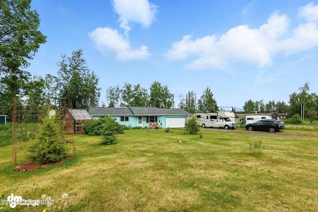 222 Crest Dr, Soldotna, AK 99669 - ranch-style house featuring a greenhouse, a front lawn, and an attached garage