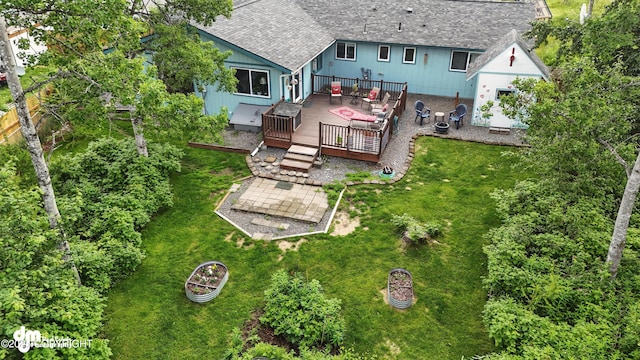 222 Crest Dr, Soldotna, AK 99669 - back of property featuring a wooden deck, roof with shingles, and a lawn