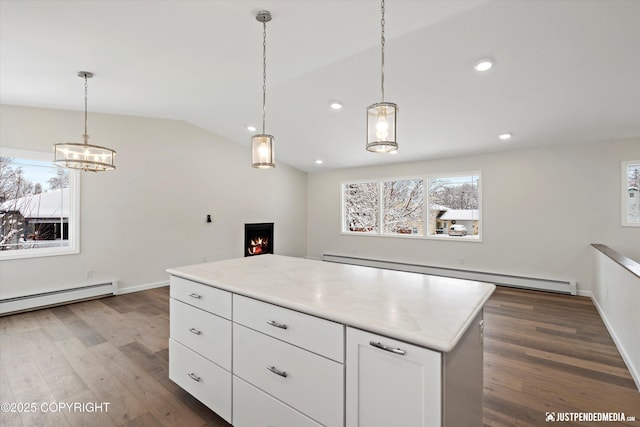 3031 Bennett Ave, Anchorage, AK 99517 - kitchen with a baseboard radiator, wood finished floors, white cabinetry, lofted ceiling, and a chandelier