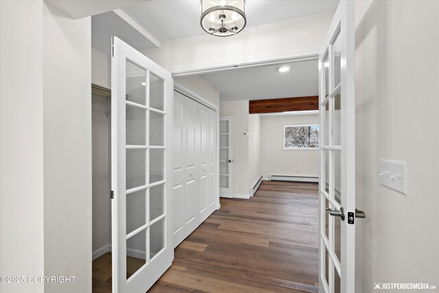 3031 Bennett Ave, Anchorage, AK 99517 - corridor featuring baseboard heating, wood finished floors, french doors, and a chandelier
