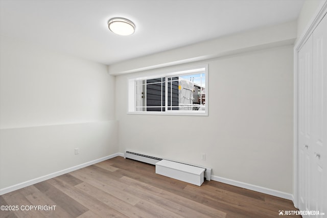 3031 Bennett Ave, Anchorage, AK 99517 - unfurnished bedroom with a closet, wood finished floors, and baseboard heating