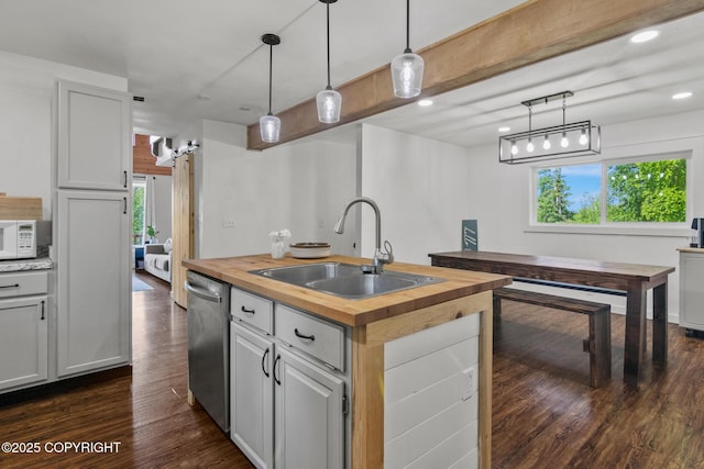 38835 Pinewood Ave, Sterling, AK 99672 - kitchen featuring butcher block countertops, dishwasher, healthy amount of natural light, an island with sink, and recessed lighting