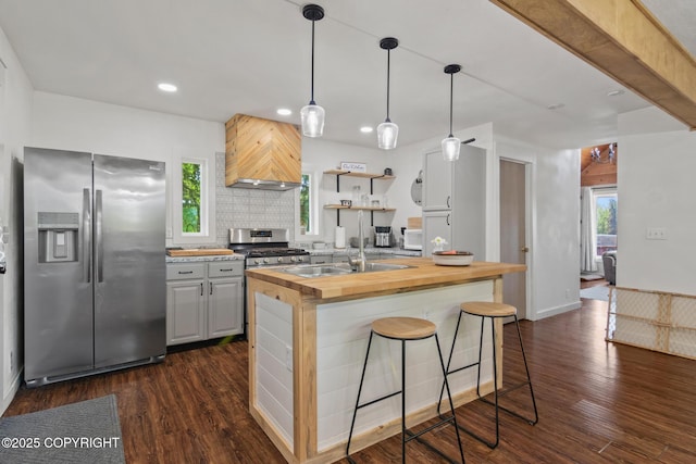 38835 Pinewood Ave, Sterling, AK 99672 - kitchen with stainless steel appliances, butcher block countertops, custom range hood, recessed lighting, and dark wood-type flooring