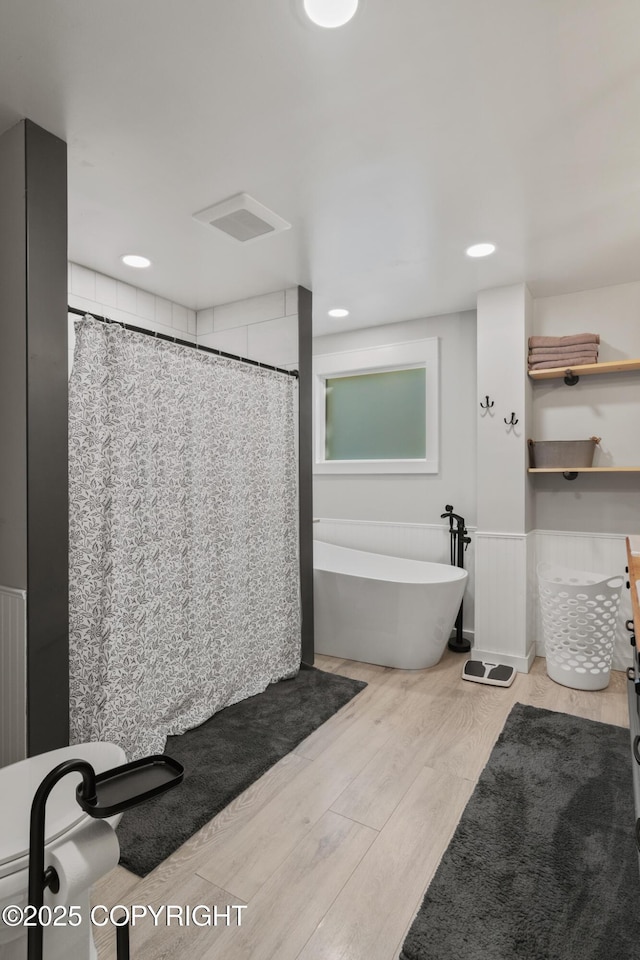 38835 Pinewood Ave, Sterling, AK 99672 - bathroom with a freestanding bath, wood finished floors, a shower with curtain, and recessed lighting