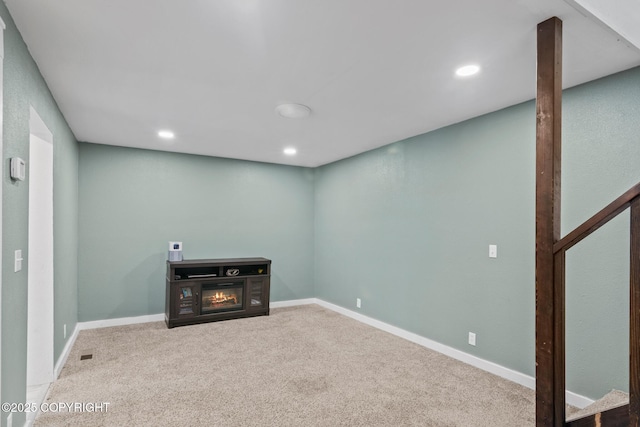 38835 Pinewood Ave, Sterling, AK 99672 - basement with carpet flooring, a glass covered fireplace, and recessed lighting