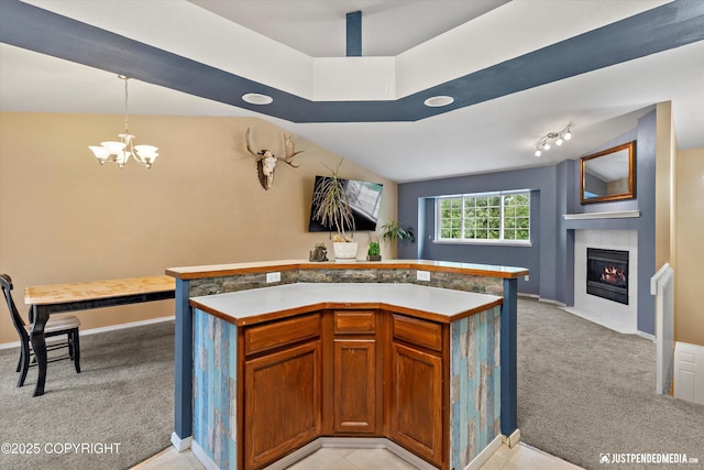 1220 S Felton St, Palmer, AK 99645 - kitchen with light colored carpet, a chandelier, a fireplace with flush hearth, light countertops, and pendant lighting