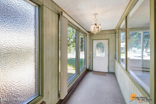 1110 F St, Anchorage, AK 99501 - unfurnished sunroom with a chandelier, carpet flooring, and a textured ceiling