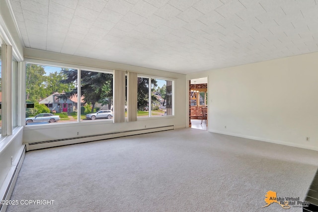 1110 F St, Anchorage, AK 99501 - empty room with healthy amount of natural light, a baseboard heating unit, and carpet flooring