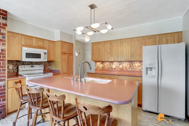 1110 F St, Anchorage, AK 99501 - kitchen featuring white appliances, tasteful backsplash, a kitchen bar, and light brown cabinetry