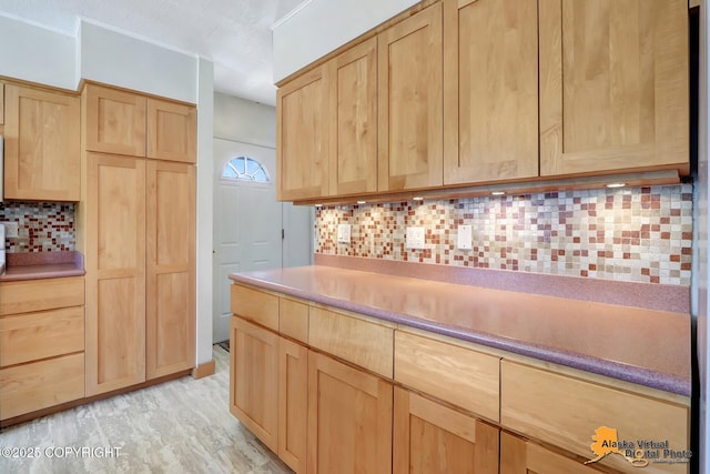 1110 F St, Anchorage, AK 99501 - kitchen with light brown cabinets, backsplash, light wood-style floors, and light countertops