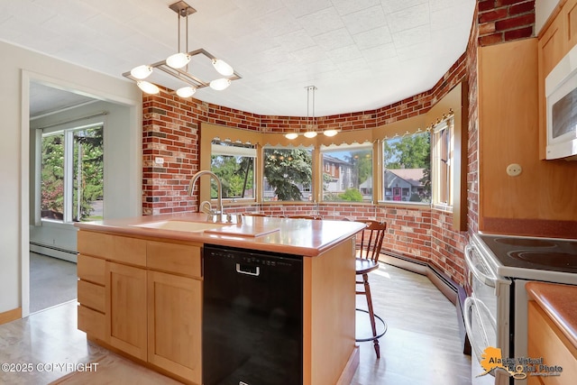 1110 F St, Anchorage, AK 99501 - kitchen with white appliances, a baseboard radiator, light brown cabinets, an island with sink, and brick wall
