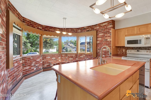 1110 F St, Anchorage, AK 99501 - kitchen with white appliances, light brown cabinets, brick wall, plenty of natural light, and a baseboard heating unit