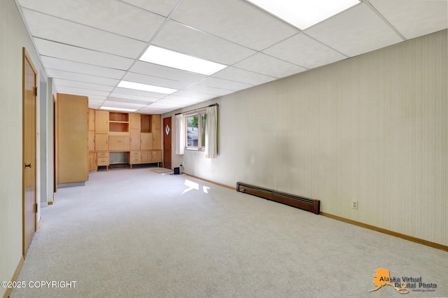 1110 F St, Anchorage, AK 99501 - below grade area with a baseboard radiator, light carpet, and a drop ceiling