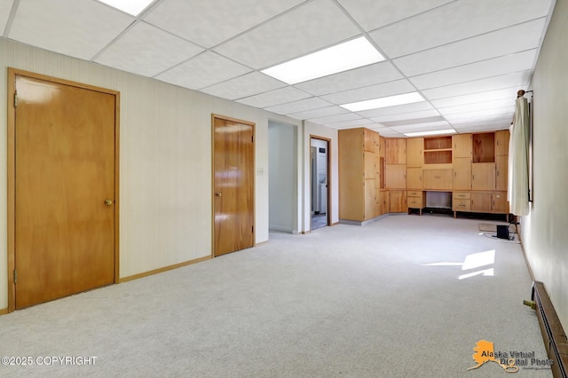 1110 F St, Anchorage, AK 99501 - basement featuring baseboard heating, carpet flooring, and a paneled ceiling