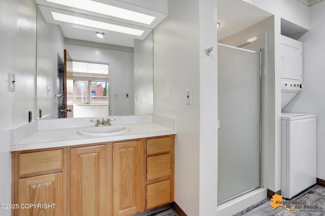 1110 F St, Anchorage, AK 99501 - full bathroom featuring stacked washer and clothes dryer, a shower stall, vanity, and a skylight