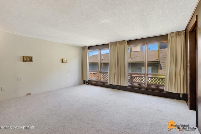 1110 F St, Anchorage, AK 99501 - carpeted empty room with a textured ceiling
