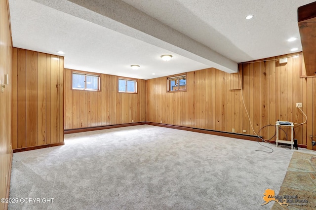 1110 F St, Anchorage, AK 99501 - below grade area with wood walls, a textured ceiling, carpet flooring, and recessed lighting