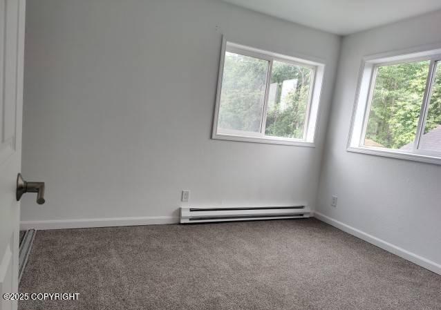 7141 Weimer Rd # 46, Anchorage, AK 99502 - carpeted empty room featuring a baseboard radiator and baseboards