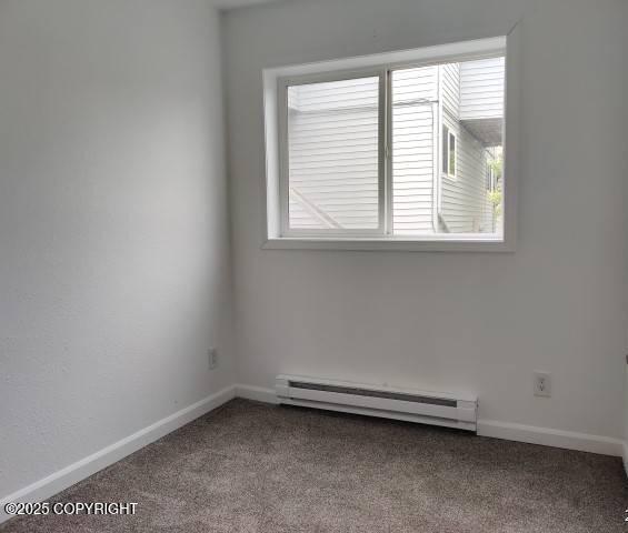 7141 Weimer Rd # 46, Anchorage, AK 99502 - empty room with baseboard heating and carpet