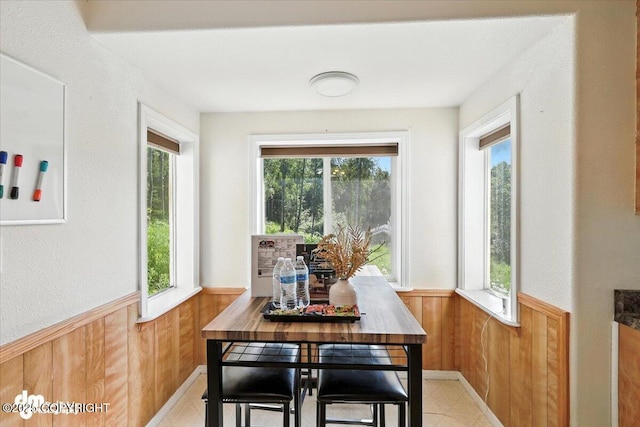 600 E Strathclyde Ln, Wasilla, AK 99654 - dining area with wood walls, a wainscoted wall, and healthy amount of natural light