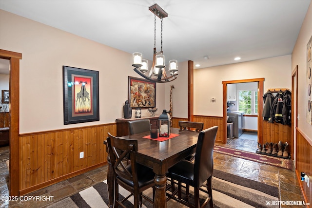 4051 Twilight Ln, Anchorage, AK 99516 - dining area featuring wainscoting, stone tile floors, wood walls, a chandelier, and recessed lighting
