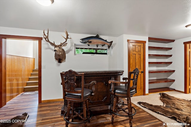 4051 Twilight Ln, Anchorage, AK 99516 - dining room featuring a bar, stairway, and dark wood-style floors