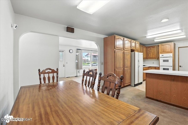275 S Hoyt St, Anchorage, AK 99508 - dining room with arched walkways and light colored carpet